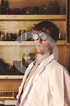 Creepy scientist weird portrait in his laboratory photo