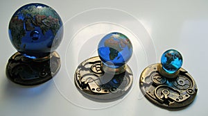 A set of 3 Glass earth geographically accurate in colourful detail.