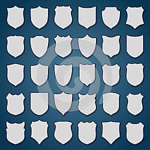Set of 30 blank shields on blue background