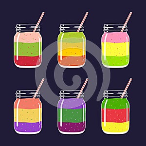 Set of 6 different fresh fruit and berry layered smoothies in mason jars with straw.