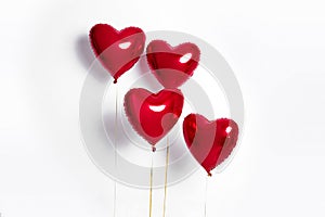 Set of Air Balloons. Bunch of red color heart shaped foil balloons isolated on white background. Love.