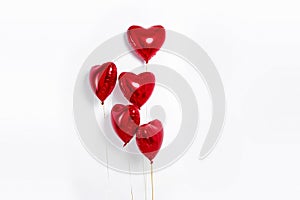 Set of Air Balloons. Bunch of red color heart shaped foil balloons isolated on white background. Love.