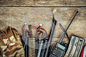 Set of airsoft game sport equipment on wooden background photo