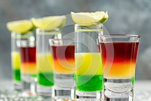 Set alcohol shot in cocktail glass. Layered Cocktail Shooter with lime