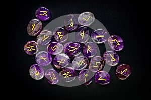 Set of amethyst rune stones on the black background