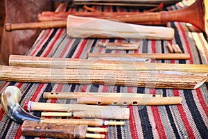 Set of ancient wind musical instruments, lifestyle. Old flutes, horns and wooden pipes on the table