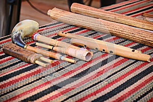 A set of ancient woodwind musical instruments. Retro pipes, flutes and horns on the table, lifestyle