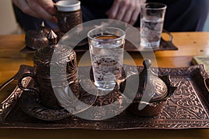 A set of antique Turkish dishes for coffee is on the table