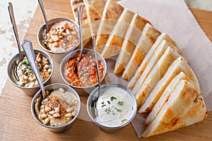 Set of appetizers: hummus, muhammara, tirokafteri, Greek cacik