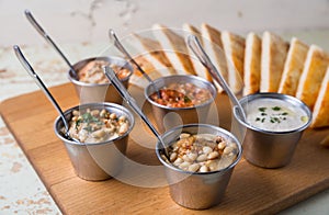 Set of appetizers: hummus, muhammara, tirokafteri, Greek cacik