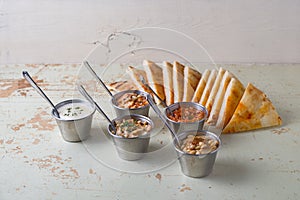 Set of appetizers: hummus, muhammara, tirokafteri, Greek cacik