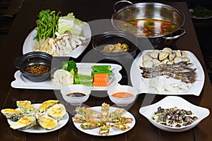 Set of Asia sea food with Coconut Escargot, barbecue razor clam, cheese grilled oyster, boiled vegetable eating with braided fish