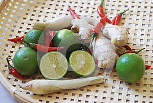 Set of asian spices: kaffir limes, lemongrass, bird`s eye chilis, ginger.