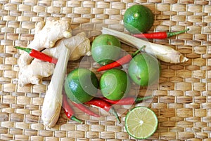 Set of asian spices: kaffir limes, lemongrass, bird`s eye chilis, ginger.