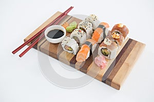 Set of assorted sushi served on wooden tray