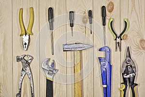 A set of assorted work carpentry and locksmith tools on a light wooden background with copy space