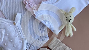 Set of baby bodysuits, pants, socks and knitted toy