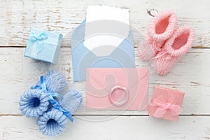 Set of baby girl and boy booties and greeting card form. Top view