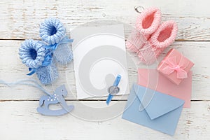 Set of baby girl and boy booties and greeting card form. Top view