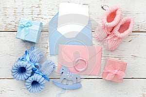 Set of baby girl and boy booties and greeting card form. Top view