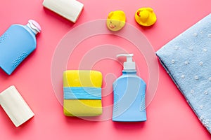 Set of baby hygiene and bath items with shampoo bottle and soap. Top view