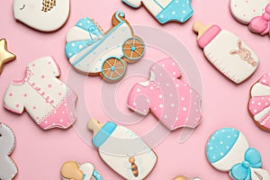 Set of baby shower cookies on light pink background, flat lay