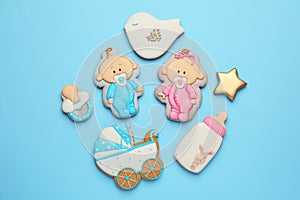 Set of baby shower cookies on turquoise background, flat lay