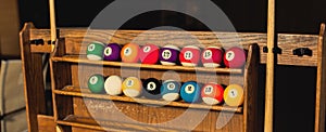 Set of balls for a game of pool billiards on shelves