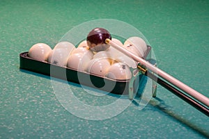 The set of balls in a triangle, to be installed before the impact of the cue on a green table