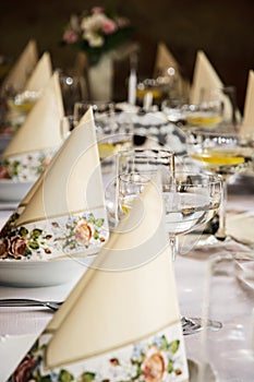 Set banquet table, decorative napkins and glasses with vermouth