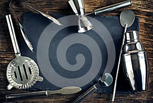 Set of bar accessories for making a cocktails arranged on a wood