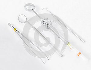 Set of  basic dentist tools on white