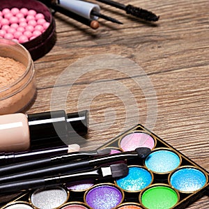 Set of basic make-up products on wooden surface