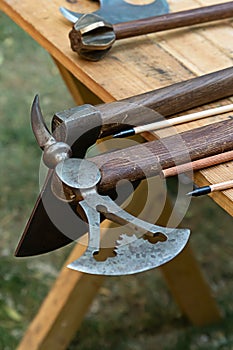 Set battle ax old viking weapon lies on the edge of the gunsmith table