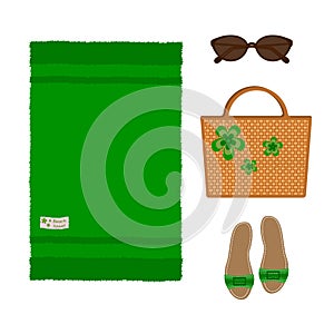 Set of beach green towel, wicker bag, sandals and sunglasses, isolated on white background