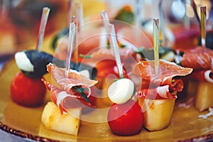 A set of beautiful canapes on golden dishes. Buffet table. Food. Fun. Close-up