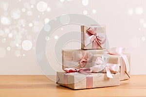 Set of beautiful different gift boxes made by handmade with pink bows on a wooden table with a light background. flat lay