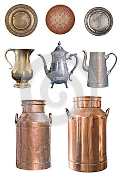 A set of beautiful old teapots, copper milkmen and plates isolated on a white background