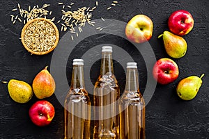 Set of beer bottles with apple, pears, wheat top-down