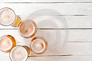 Set of beer glasses on vintage wooden background with copyspace.