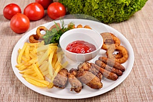 Set of beer snacks, fried potatoes, nuggets and sauce