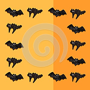Set of black bats with cats isolated on orange color background. Halloween ornament is colorful Tones
