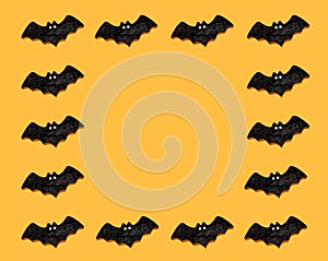 Set of black bats isolated on orange color background. Halloween ornament is colorful Tones