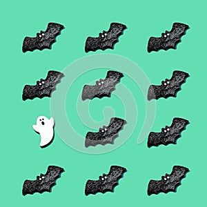 Set of black bats with a white ghost isolated on green color background. Halloween ornament is colorful Tones