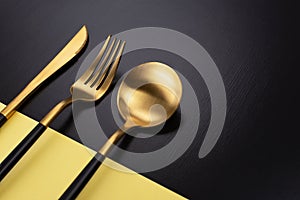 Set of black and gold cutlery