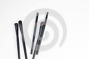 A set of black makeup brushes ISOLATED on a white background, a copy of the space, the concept of care and beauty make-up