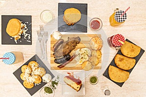 Set of black plates full of typical Colombian paisa food recipes, with roasts, tropical fruit juices, corn empanadas, cheesecake