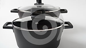 Set of black pots on a white background. Utensils for cooking