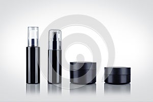 Set of black shiny cosmetic dispenser bottles and cartridges