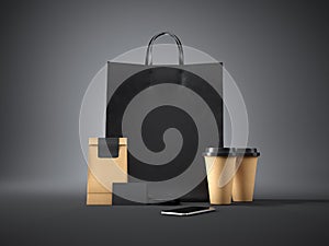 Set of black shopping bag, coffee cups, paper package, blank business cards and generic design smartphone. 3d render